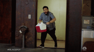 Man Carrying Red And White Cooler With NBC Logo GIF