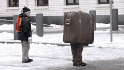 Man Carrying Suitcase On Back In Snow GIF