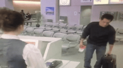 Man Carrying Suitcase Talking To Woman GIF
