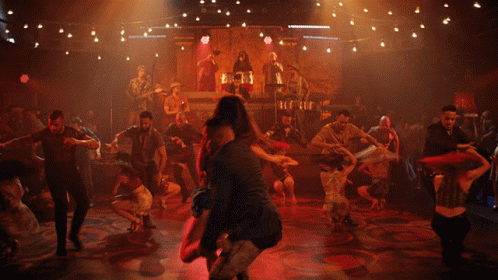 Man Carrying Woman In Arms On Dance Floor GIF
