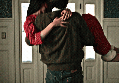 Man Carrying Woman In Santa Sweater GIF