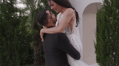 Man Carrying Woman Looking At Each Other GIF
