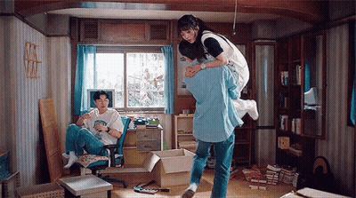 Man Carrying Woman On Back In Messy Room GIF