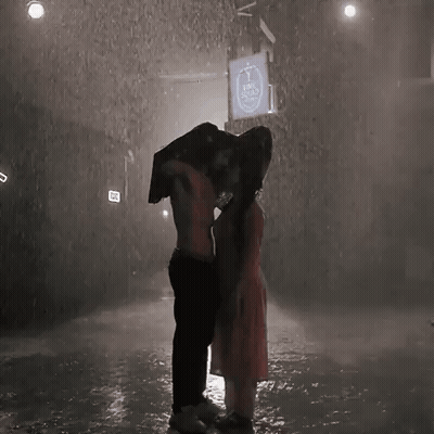 Man Carrying Woman On His Back In Rain GIF