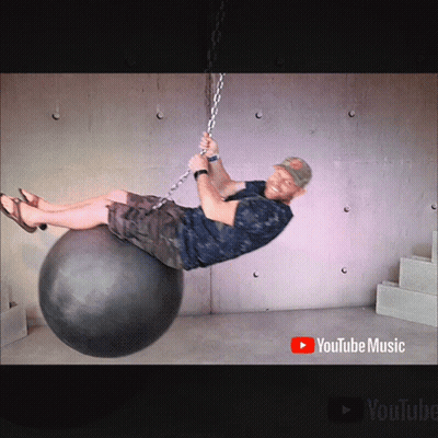 Man Chained To Ball With YouTube Music Logo GIF