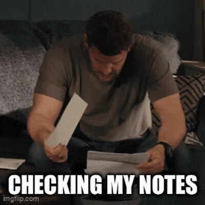 Man Checking Notes On Bed GIF