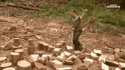 Man Chopping Wood With Axe In Log Pile GIF