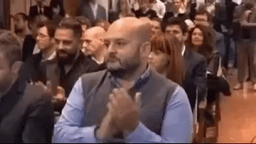 Man Clapping Hands In Front Of Crowd At Conference GIF
