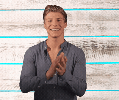 Man Clapping Hands In Front Of Wooden Wall GIF