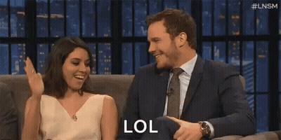Man Clapping While Woman Says LOL On Couch GIF
