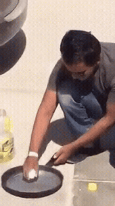 Man Cleaning Pan With Sponge GIF