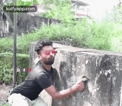 Man Cleaning Wall With Brush GIF