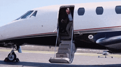 Man Climbing Airplane Stairs On Runway GIF