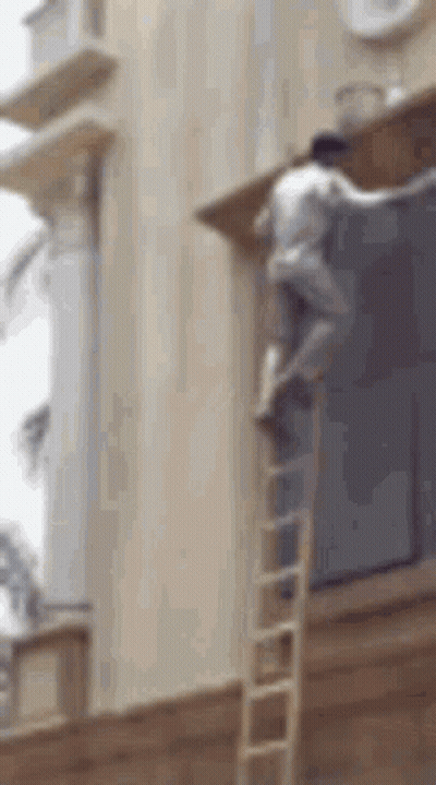 Man Climbing Ladder To Paint Building GIF
