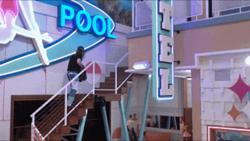 Man Climbing Stairs Near Pool Sign GIF