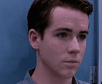Man Close Up Against Blue Door GIF