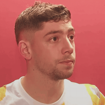 Man Close Up Against Red Wall GIF