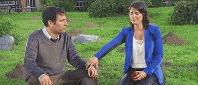 Man Comforting Crying Woman On Grass GIF