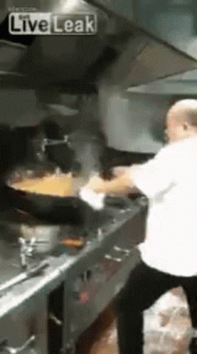 Man Cooking Food In Kitchen GIF