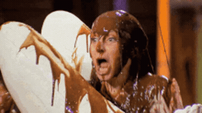 Man Covered In Chocolate Holding White Heart GIF