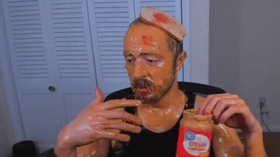 Man Covered In Peanut Butter Holding Jar GIF