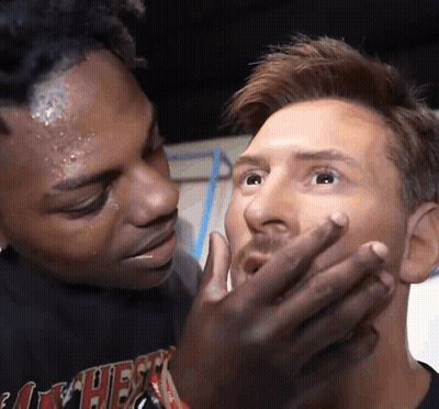 Man Covering Another's Mouth Wearing Heat Shirt GIF