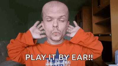 Man Covering Ears Saying Play It By Ear GIF