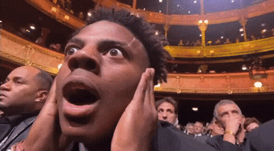 Man Covering Ears While Watching Show GIF
