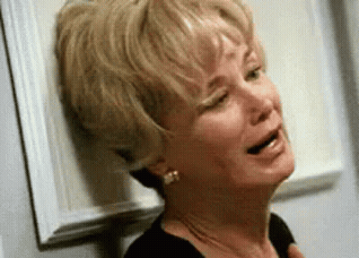 Man Covering Eyes In Front Of Bang Energy Wall GIF