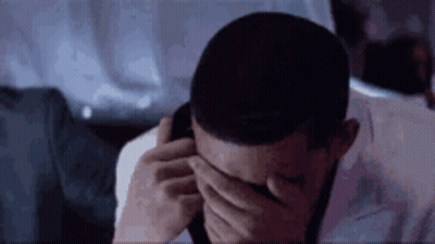 Man Covering Eyes While Talking On Cell Phone GIF
