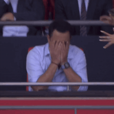 Man Covering Face as Woman Looks On
