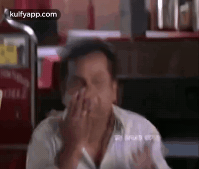 Man Covering Face At Restaurant Table GIF
