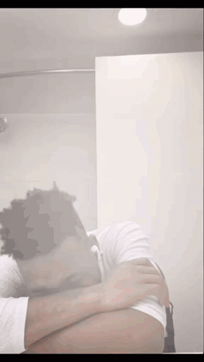 Man Covering Face in Bathroom