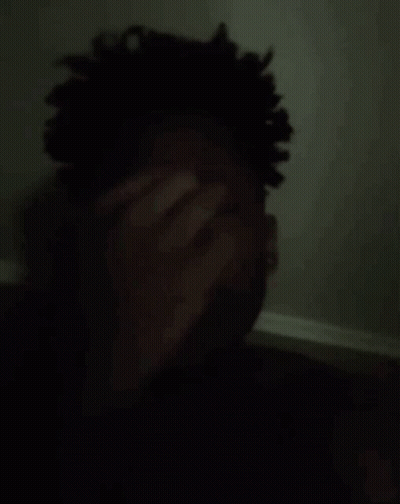 Man Covering Face In Dark GIF