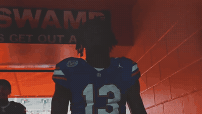 Man Covering Face In Florida Gators Jersey GIF