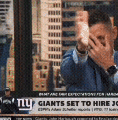 Man Covering Face In Front Of NY Giants Ad GIF