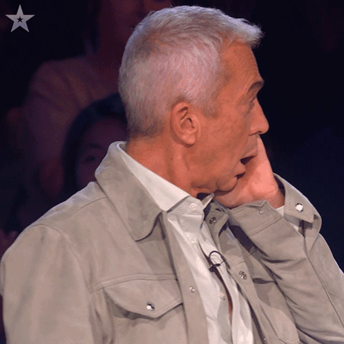 Man Covering Face With Hand And Star On Bottom Left GIF