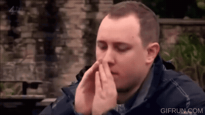 Man Covering Face With Hands At Table GIF