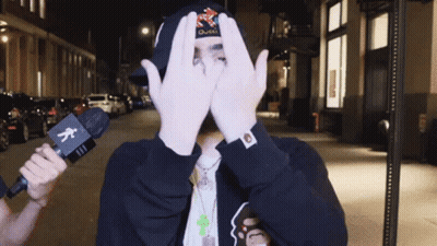 Man Covering Face With Hands Holding Microphone GIF
