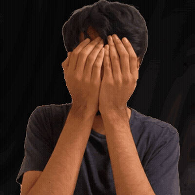 Man Covering Face With Hands In Black Shirt GIF