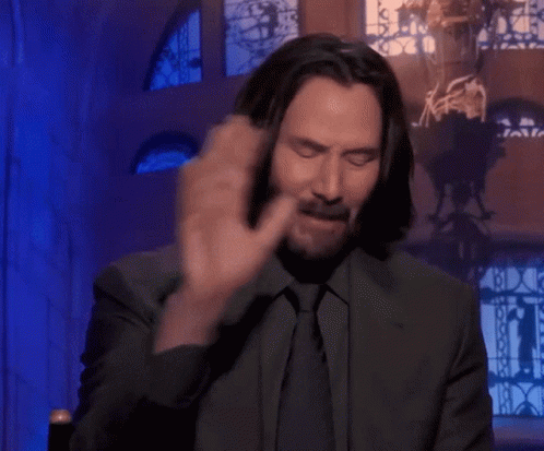 Man Covering Face With Hands In Front Of Stained Glass Window GIF