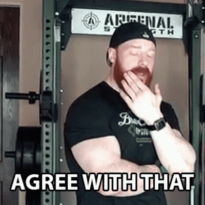 Man Covering Mouth In Front Of Arsenal Sign GIF