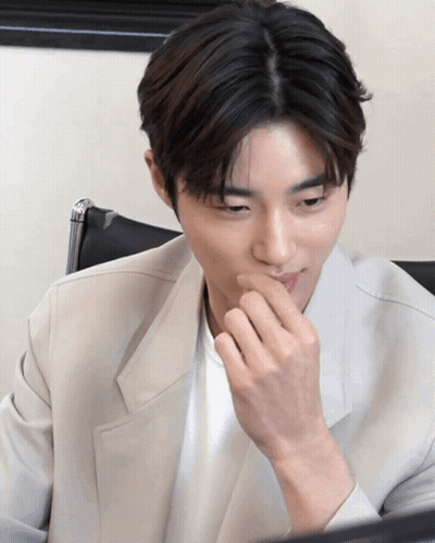 Man Covering Mouth Looking Down GIF