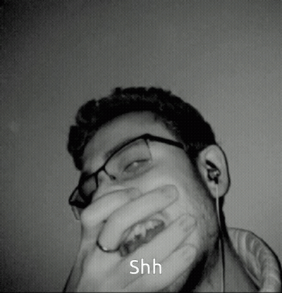 Man Covering Mouth Saying Shh GIF