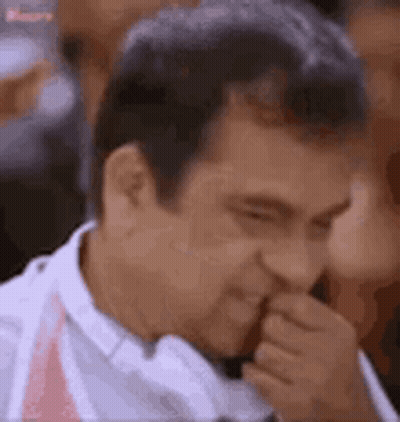 Man Covering Mouth While Looking GIF