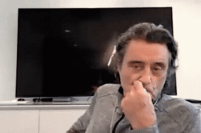 Man Covering Nose In Front Of Flat Screen TV GIF