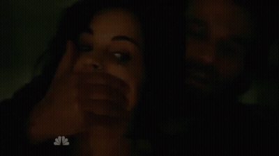 Man Covering Woman's Mouth In The Dark GIF