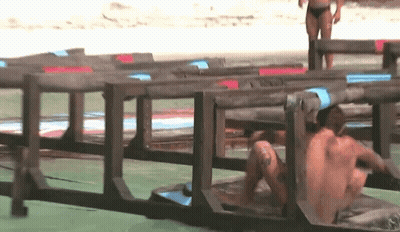 Man Crawling Through Wooden Fence Woman In Background GIF