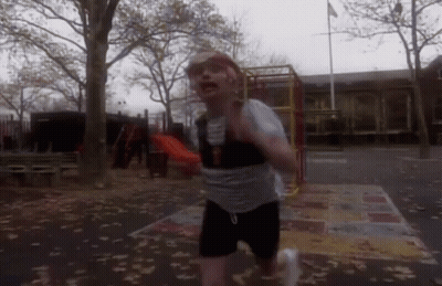 Man Crawling Under Yellow Ladder With Soccer Ball GIF