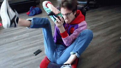 Man Crossed Legs Looking At Phone GIF